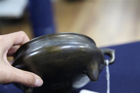 A Chinese brown patinated bronze ding censer, Xuande six character mark, probably 17th/18th century, width 21cm